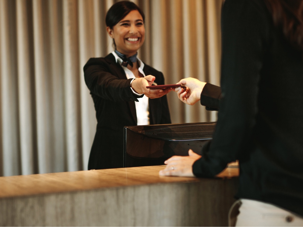 Hotel team member handing a guest their room key