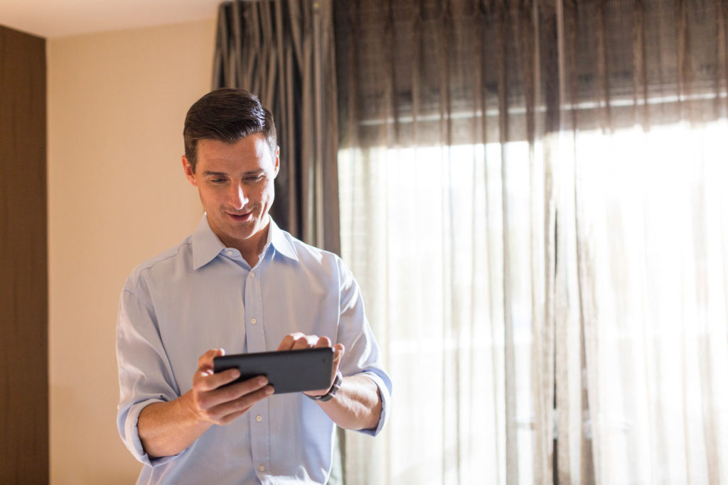 Hotel staff using digital tablet to verify guest information