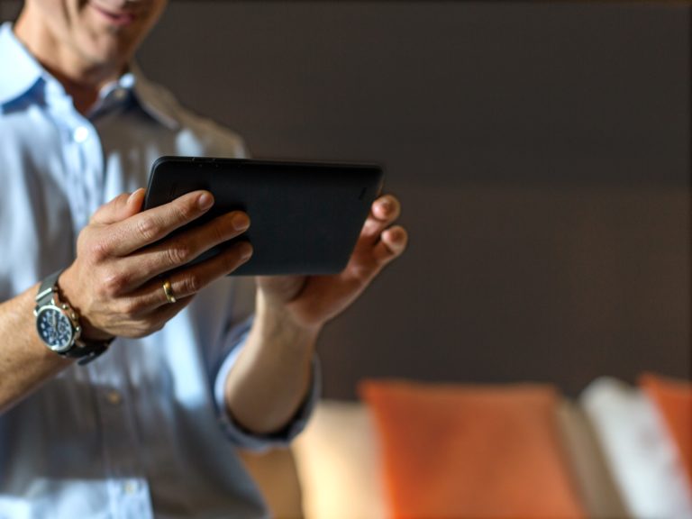 Photo of a man holding a tablet